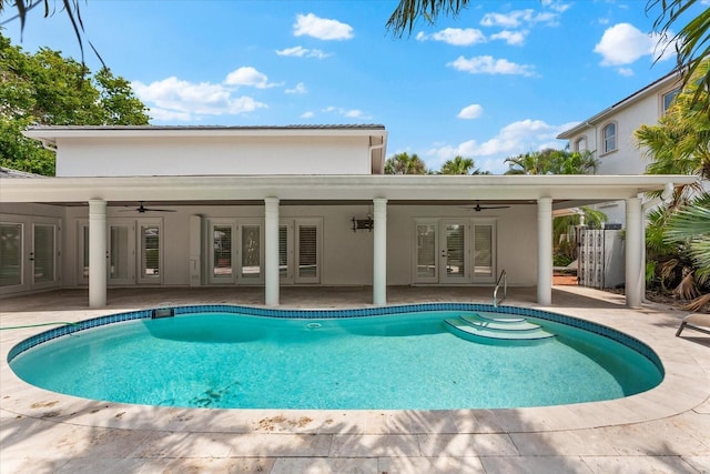 outdoor pool featuring french doors, ceiling fan, and a patio