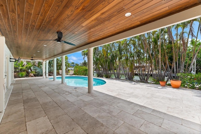 swimming pool with ceiling fan and a patio