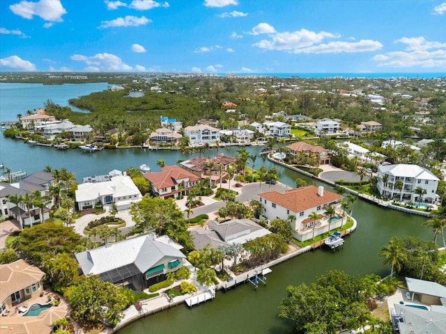 aerial perspective of suburban area with a nearby body of water