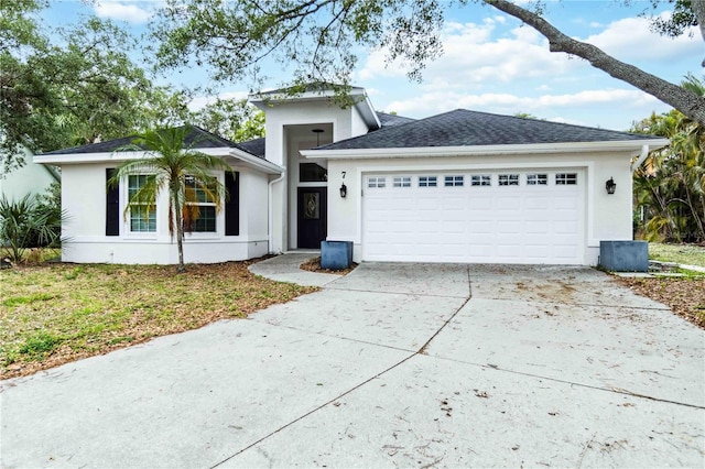 ranch-style house featuring stucco siding, an attached garage, and concrete driveway