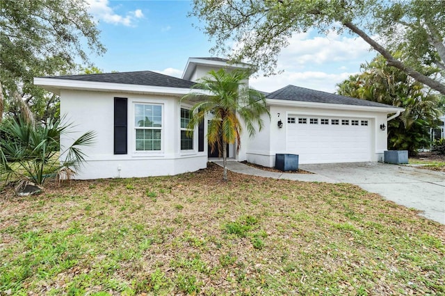 ranch-style house with a garage, driveway, stucco siding, and a front yard