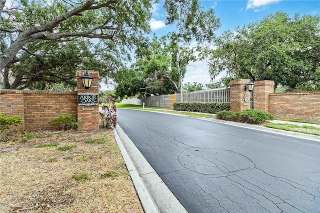view of asphalt road featuring curbs