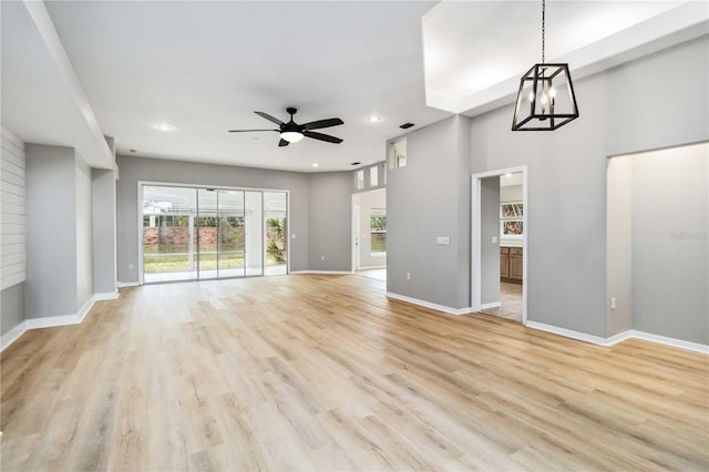 unfurnished living room featuring a ceiling fan, light wood-type flooring, recessed lighting, and baseboards