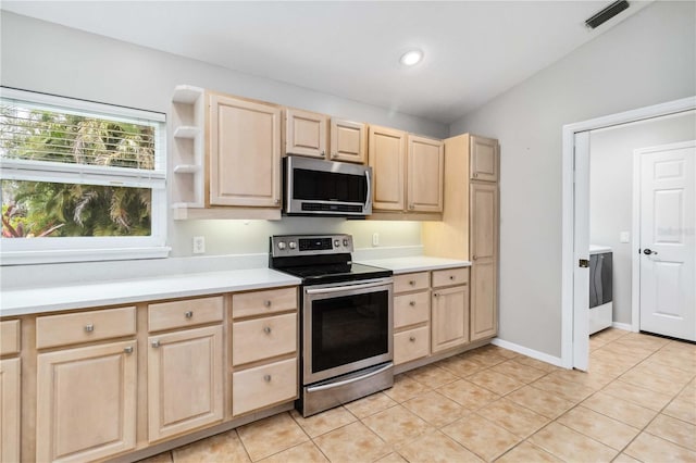 kitchen with light brown cabinets, appliances with stainless steel finishes, light countertops, light tile patterned floors, and recessed lighting