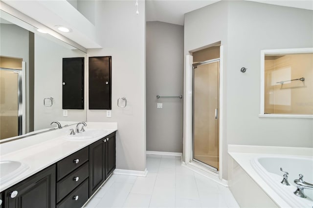 full bath featuring a shower stall, double vanity, tile patterned flooring, a garden tub, and baseboards