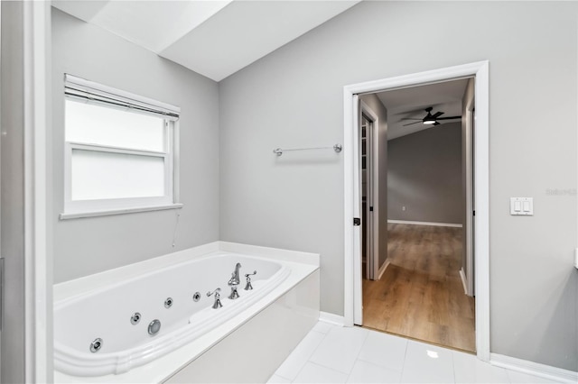 bathroom featuring a whirlpool tub, baseboards, tile patterned floors, and a ceiling fan