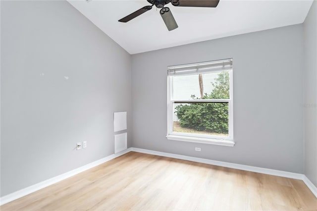unfurnished room with light wood-type flooring, baseboards, vaulted ceiling, and a ceiling fan