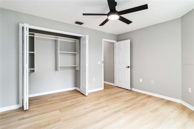 unfurnished bedroom with wood finished floors, a closet, baseboards, and ceiling fan