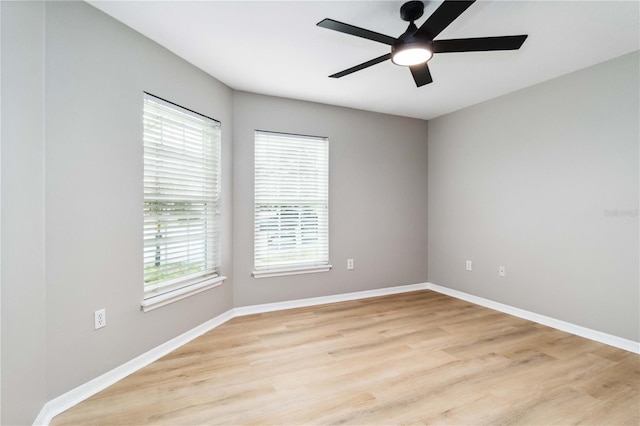 empty room with light wood-type flooring, ceiling fan, and baseboards