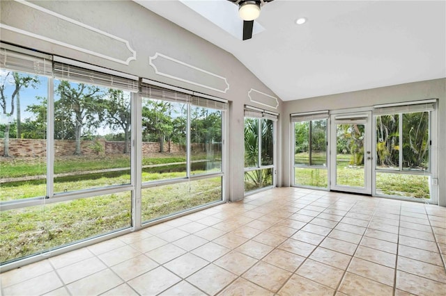 unfurnished sunroom featuring vaulted ceiling, tile patterned floors, a ceiling fan, and french doors