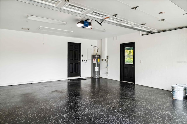 garage featuring electric water heater, a garage door opener, and concrete block wall