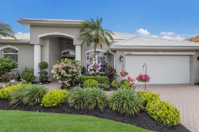 3806 72nd Ter E, Sarasota, FL 34243 - mediterranean / spanish home featuring an attached garage, stucco siding, and a tile roof