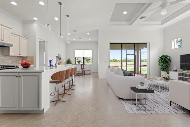 living area with crown molding, recessed lighting, light tile patterned floors, a high ceiling, and a ceiling fan