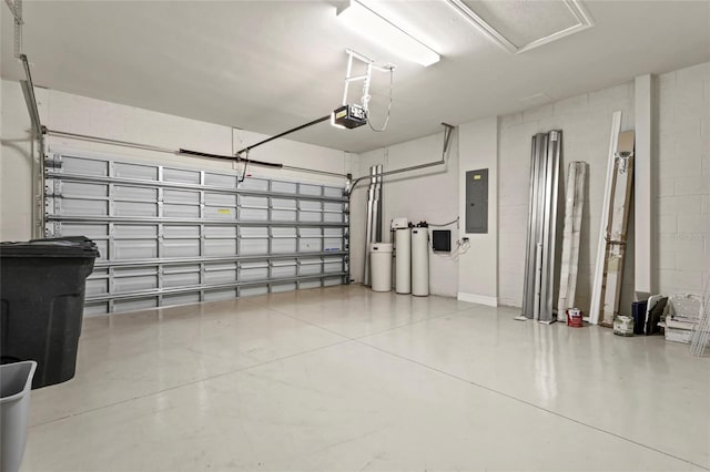 garage with a garage door opener, electric panel, and concrete block wall