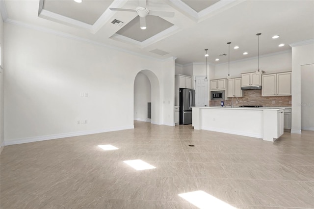 unfurnished living room featuring a sink, arched walkways, a ceiling fan, crown molding, and recessed lighting