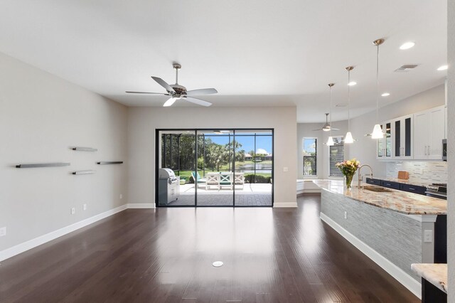 8191 Gabanna Dr, Sarasota, FL 34231 - unfurnished living room featuring a sink, a ceiling fan, baseboards, dark wood-type flooring, and recessed lighting