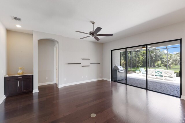 8191 Gabanna Dr, Sarasota, FL 34231 - spare room featuring arched walkways, ceiling fan, baseboards, dark wood finished floors, and recessed lighting