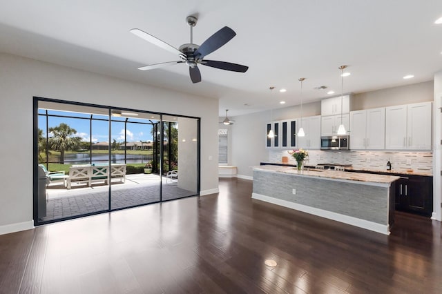 8191 Gabanna Dr, Sarasota, FL 34231 - kitchen featuring stainless steel microwave, tasteful backsplash, recessed lighting, baseboards, and ceiling fan