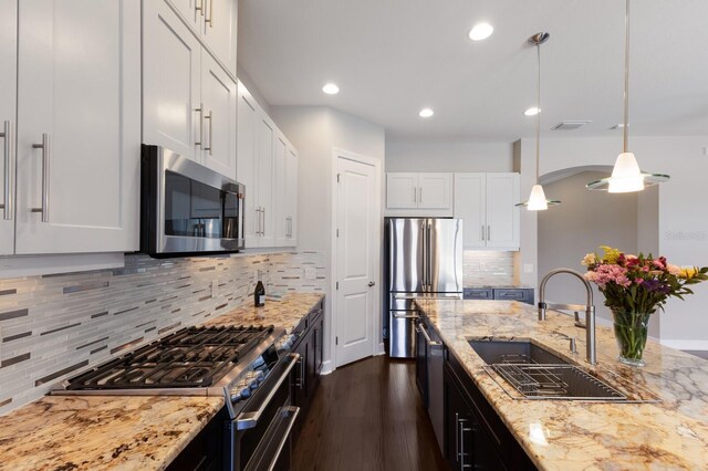 8191 Gabanna Dr, Sarasota, FL 34231 - kitchen with stainless steel appliances, a sink, recessed lighting, dark wood-style floors, and white cabinets