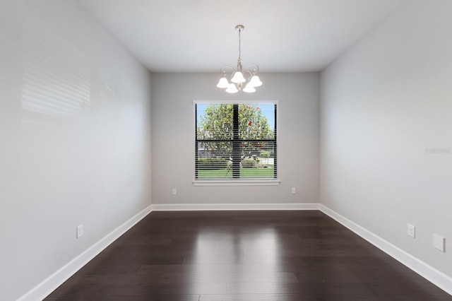 8191 Gabanna Dr, Sarasota, FL 34231 - spare room featuring a chandelier, dark wood finished floors, and baseboards