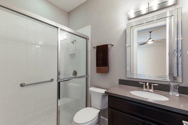 8191 Gabanna Dr, Sarasota, FL 34231 - bathroom with toilet, a stall shower, vanity, and a ceiling fan