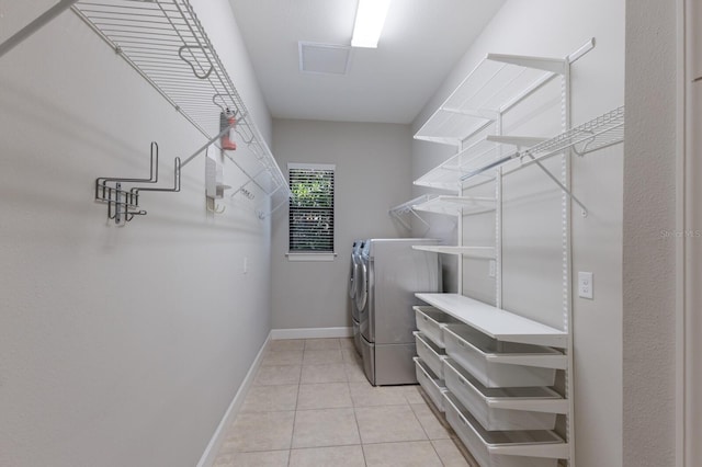 8191 Gabanna Dr, Sarasota, FL 34231 - laundry room featuring independent washer and dryer, light tile patterned flooring, and baseboards