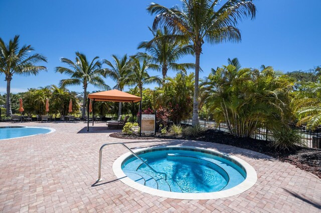 8191 Gabanna Dr, Sarasota, FL 34231 - view of swimming pool featuring a gazebo, a swimming pool, a patio, and a hot tub