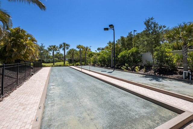 8191 Gabanna Dr, Sarasota, FL 34231 - view of swimming pool featuring a bocce ball area and view of wooded area