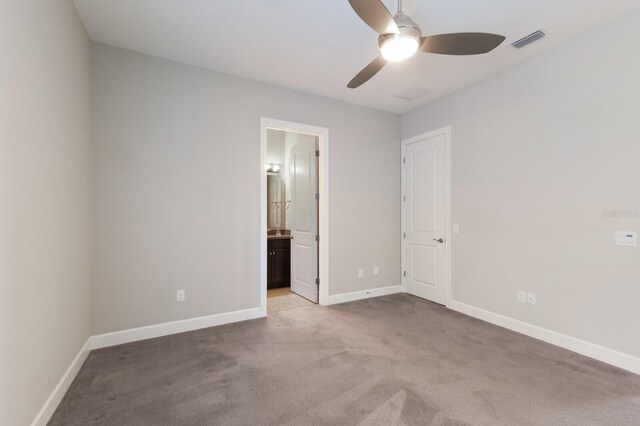 8191 Gabanna Dr, Sarasota, FL 34231 - unfurnished bedroom featuring light colored carpet, baseboards, ensuite bathroom, and a ceiling fan
