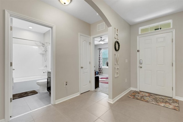 5111 11th St E, Bradenton, FL 34203 - entryway with arched walkways, baseboards, and light tile patterned flooring