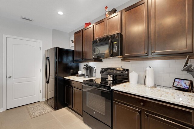 5111 11th St E, Bradenton, FL 34203 - kitchen with black appliances, backsplash, light stone counters, and dark brown cabinetry