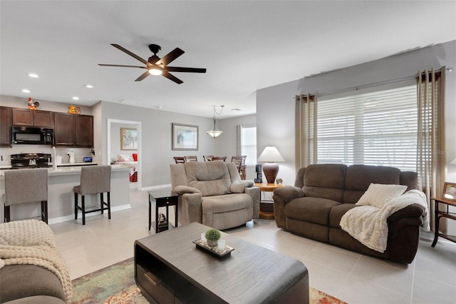 5111 11th St E, Bradenton, FL 34203 - living room with a ceiling fan, recessed lighting, light tile patterned flooring, and baseboards