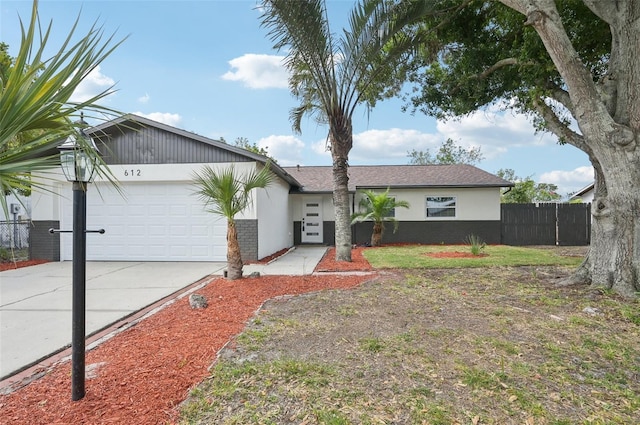 612 65th Ave W, Bradenton, FL 34207 - view of front of house with fence, a garage, stucco siding, and driveway