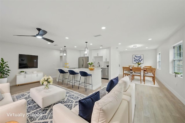 612 65th Ave W, Bradenton, FL 34207 - living area with light wood-style floors, a ceiling fan, recessed lighting, and baseboards