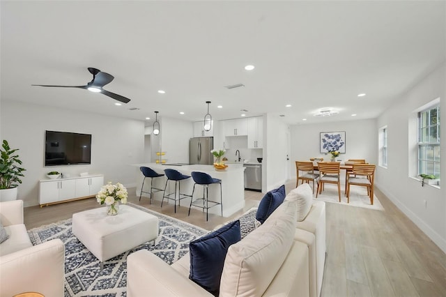 612 65th Ave W, Bradenton, FL 34207 - living room with light wood-type flooring, a ceiling fan, baseboards, and recessed lighting