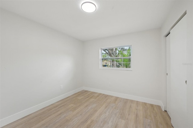 612 65th Ave W, Bradenton, FL 34207 - unfurnished bedroom with baseboards, light wood-style flooring, and a closet