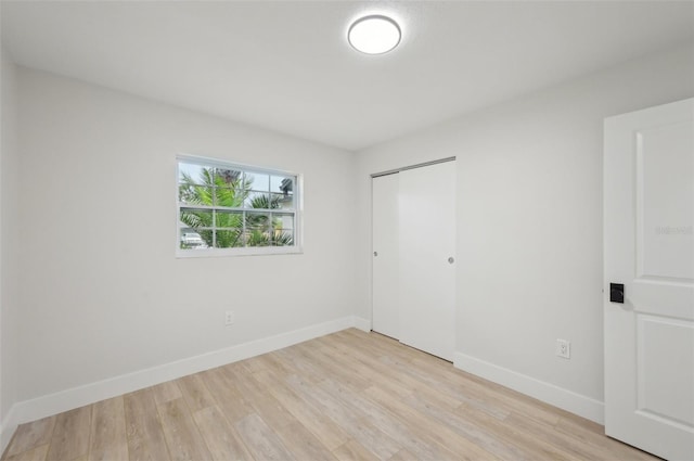 612 65th Ave W, Bradenton, FL 34207 - unfurnished bedroom with light wood finished floors, a closet, and baseboards
