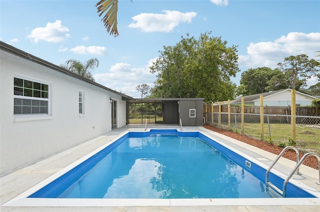 612 65th Ave W, Bradenton, FL 34207 - view of swimming pool with fence, an outbuilding, and a storage unit
