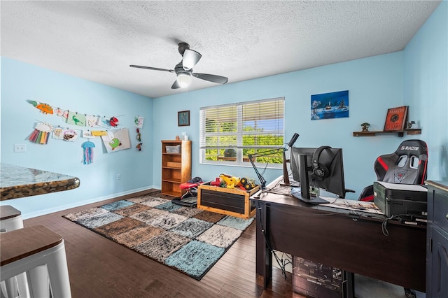 home office with ceiling fan, wood finished floors, baseboards, and a textured ceiling