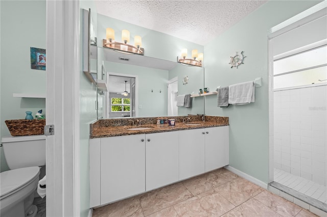 full bath featuring walk in shower, toilet, double vanity, and a textured ceiling