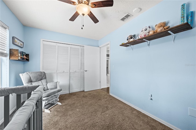 living area with carpet floors, a ceiling fan, and baseboards