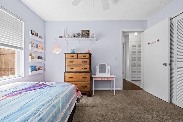 carpeted bedroom featuring a ceiling fan and a closet