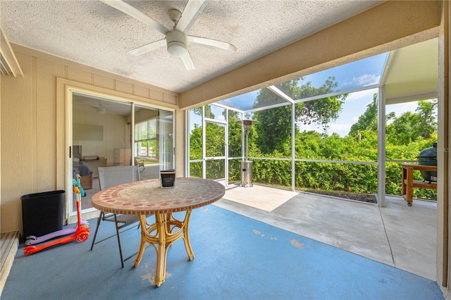 sunroom / solarium with a ceiling fan
