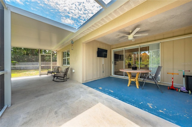 view of patio featuring a ceiling fan and fence