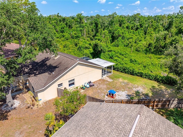 view of subject property with a heavily wooded area