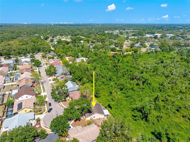 aerial view of residential area featuring a forest