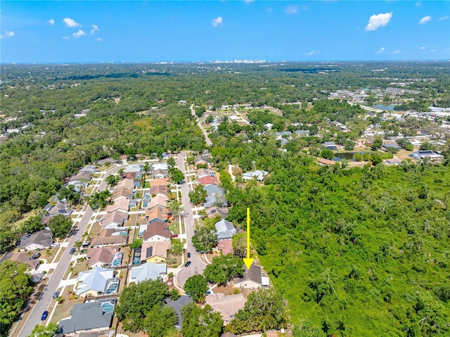 aerial view of residential area with a heavily wooded area
