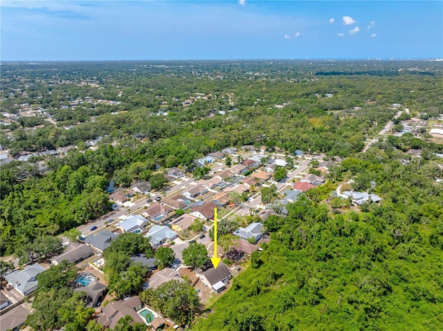 aerial overview of property's location with nearby suburban area and a forest
