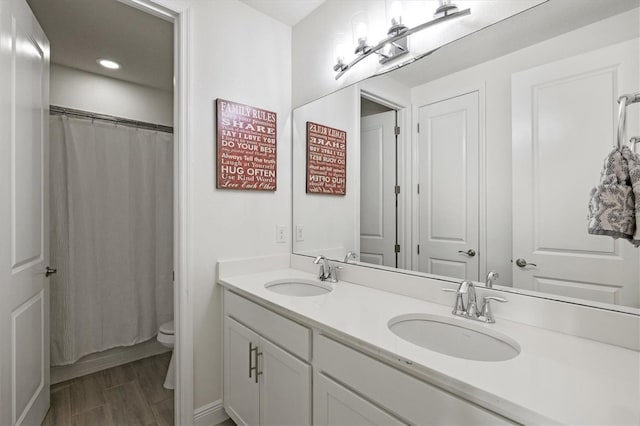 5823 Title Row Dr, Bradenton, FL 34210 - bathroom featuring toilet, double vanity, recessed lighting, and a shower with shower curtain
