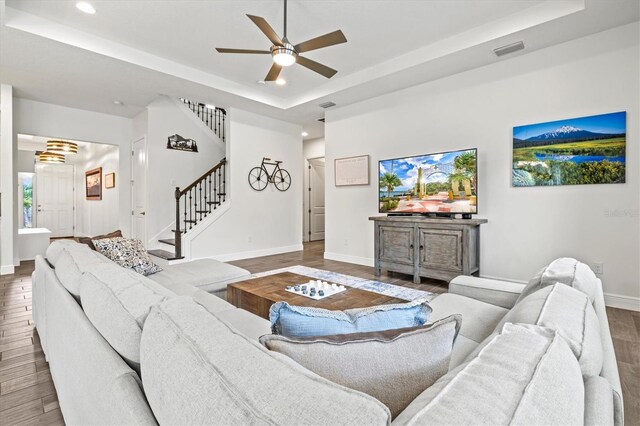 5823 Title Row Dr, Bradenton, FL 34210 - living area featuring a tray ceiling, wood finished floors, ceiling fan, stairs, and recessed lighting
